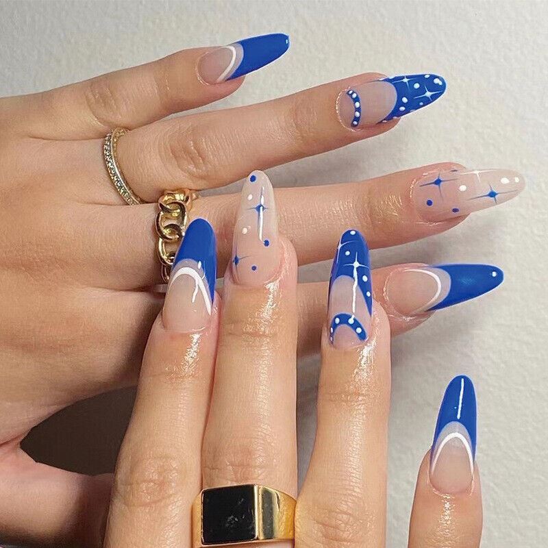 Hand with blue and white nail art on a light background