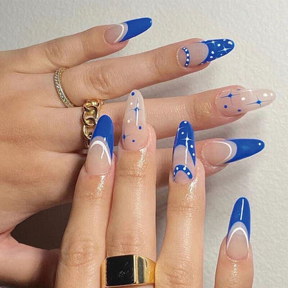 Hand with blue and white nail art on a light background