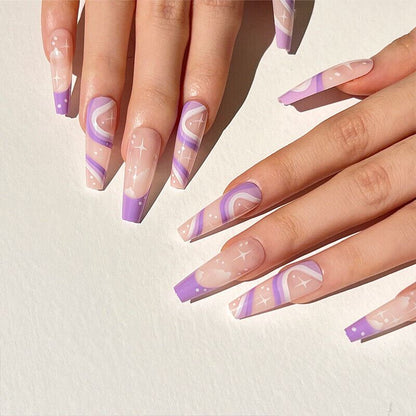Nails with a gradient design featuring purple and pink on a light background