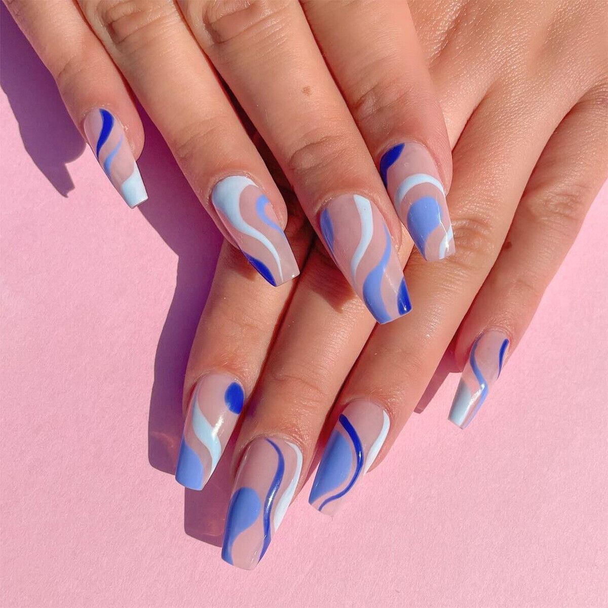 Nails with blue and white wave design on a pink background