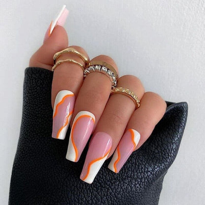 Nail art with pink and orange design on a white background
