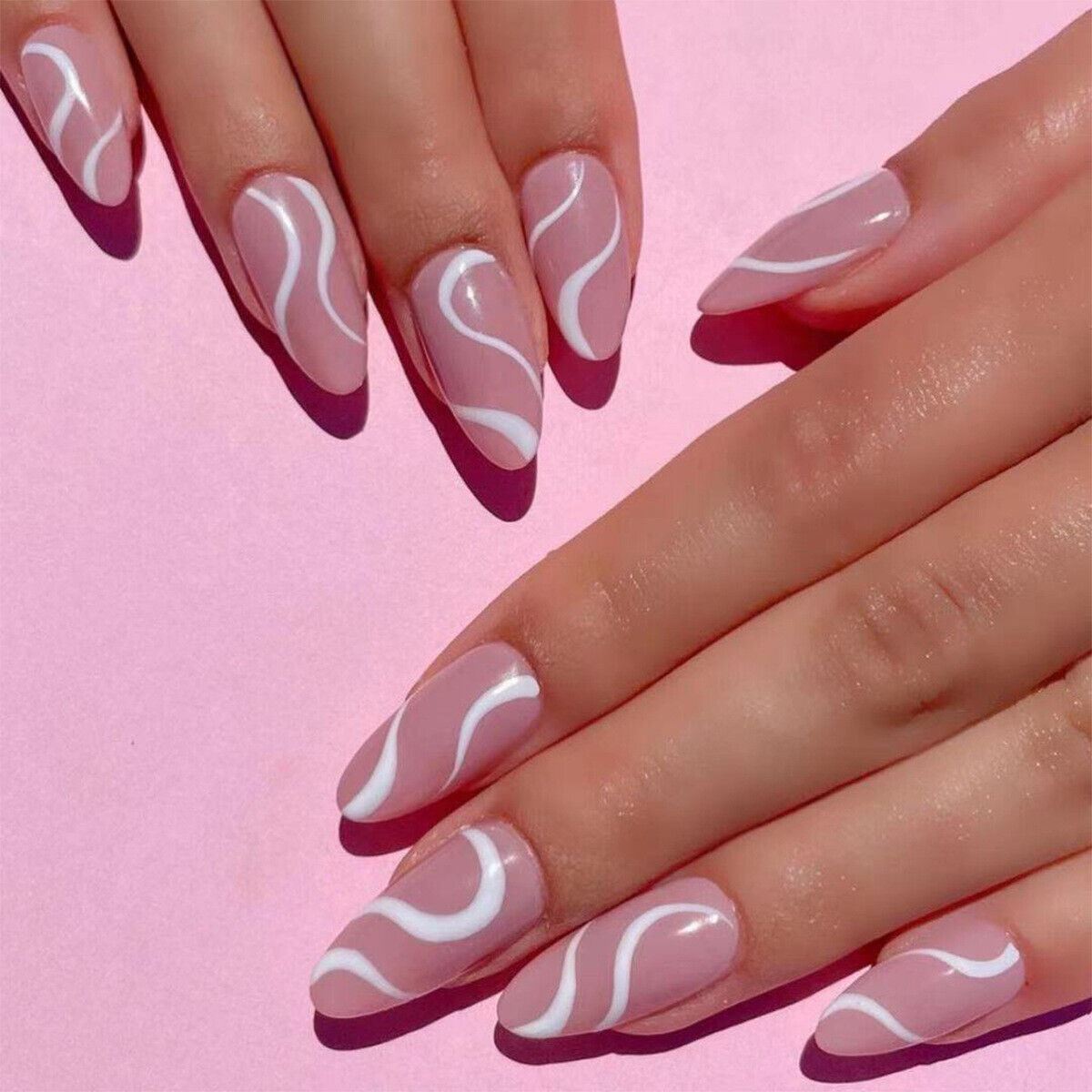 Nails with pink and white wave design on a pink background