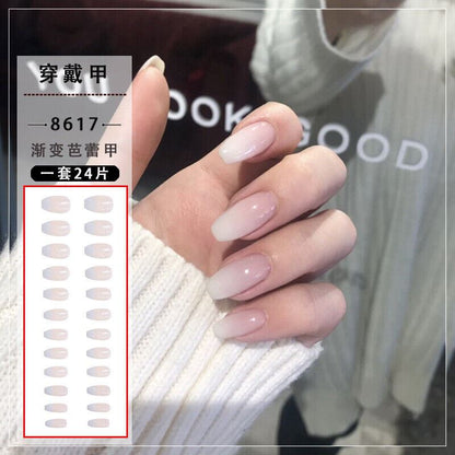 A close-up of a hand wearing long, glossy, ombre-style press-on nails, with a graphic inset showing the nail color options and Chinese text. The nails transition from very pale pink to soft nude/beige.