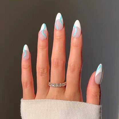 Hand with turquoise and white nail design on a dark background