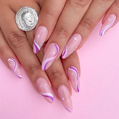 Nails with pink and purple design on a pink background