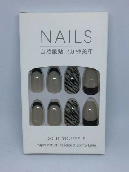 A white retail box containing a set of press-on nails. The box has a clear window showing eight almond-shaped nails with neutral designs: three are solid taupe-beige, three are black and white zebra stripes, and three are solid black French tips.