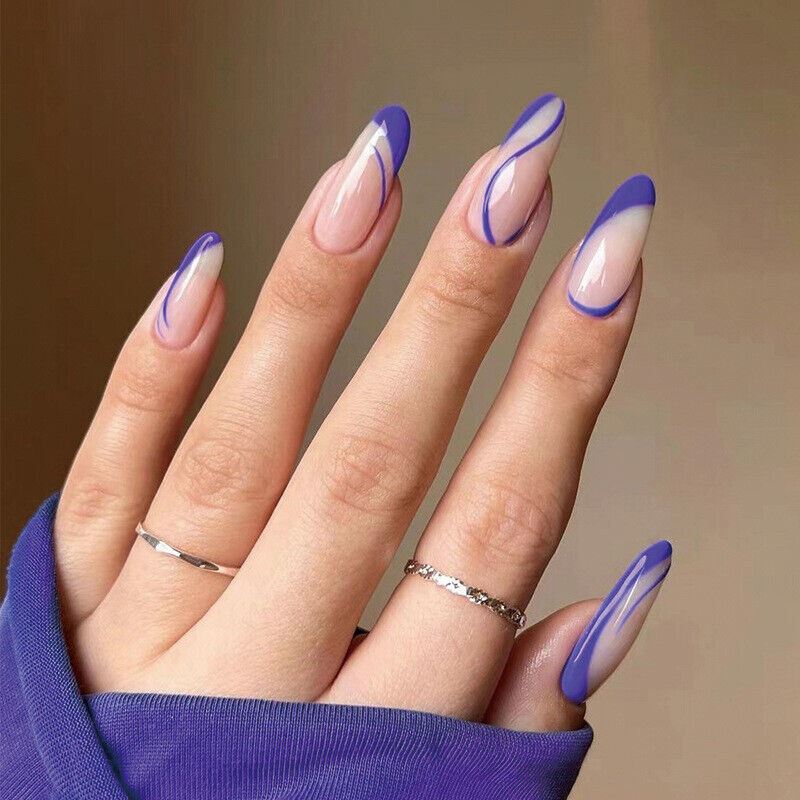 Hand with purple and white nail design on a neutral background