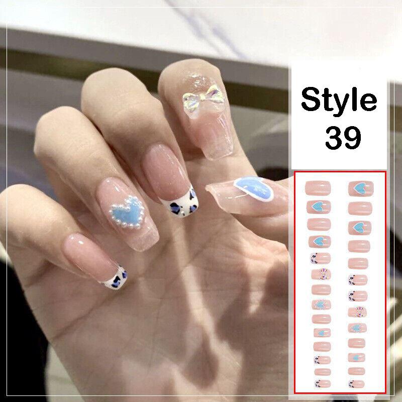 A hand displaying manicured nails with a French tip style and decorative blue, white, and pearl designs, alongside a vertical inset showing multiple nail tip options labeled 'Style 39'.