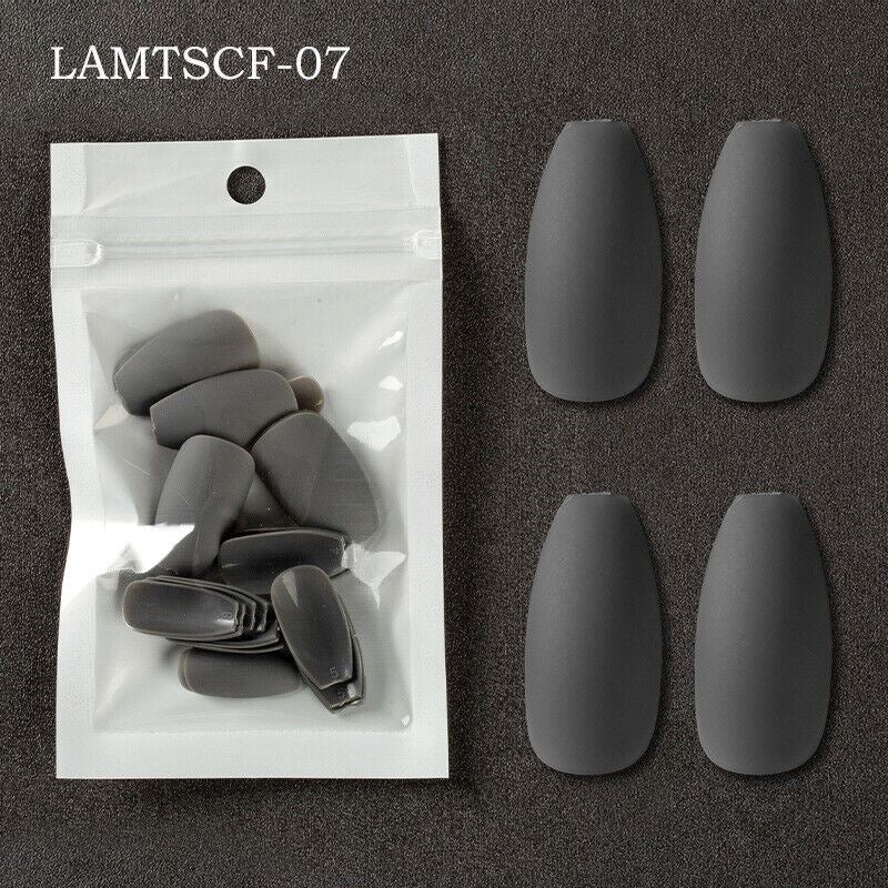 Six matte dark gray coffin-shaped press-on nails displayed next to their clear plastic packaging on a dark textured background, with the text 'LAMTSCF-07' in the top left corner.