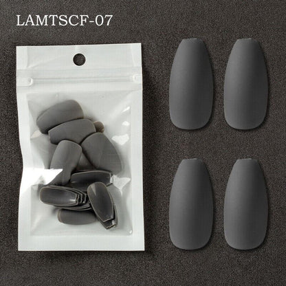 Six matte dark gray coffin-shaped press-on nails displayed next to their clear plastic packaging on a dark textured background, with the text 'LAMTSCF-07' in the top left corner.
