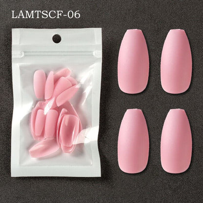 Pink coffin-shaped press-on nails shown both inside a clear resealable pouch and as four loose nails arranged on a dark textured background. Text in the top left reads LAMTSCF-06.