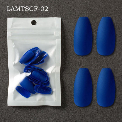 Four blue coffin-shaped press-on nails displayed next to a clear plastic bag containing additional blue nail tips, on a dark gray textured background. The text 'LAMTSCF-02' is visible in the top left corner.