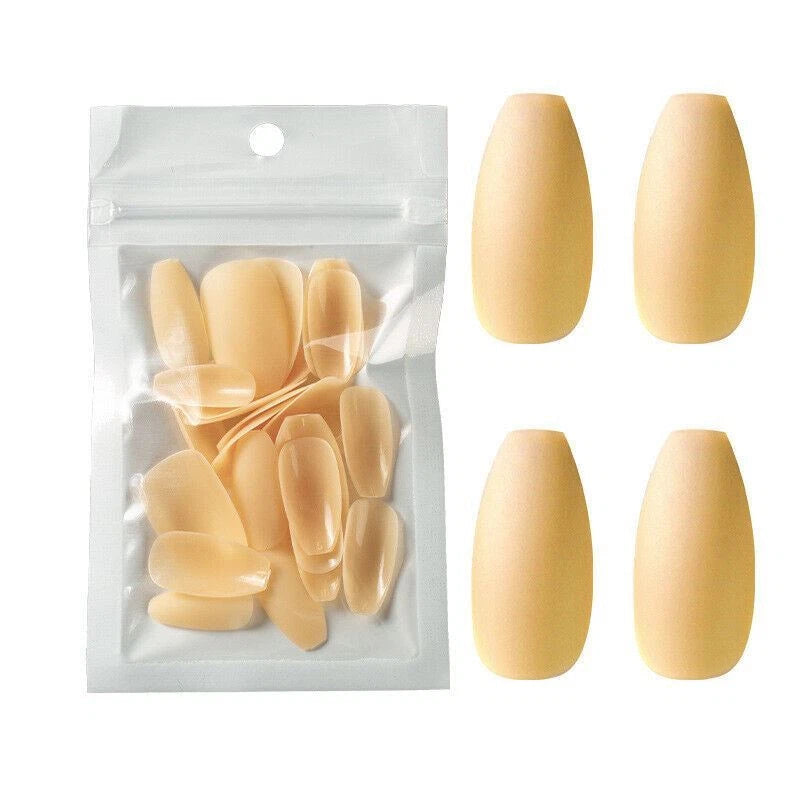 A set of nude beige press-on nails shown both inside a clear resealable pouch and as four individual false nails arranged on a white background.