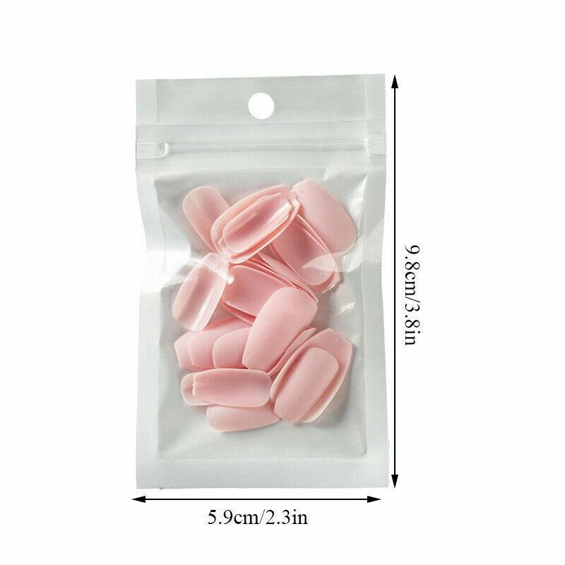 A clear plastic stand-up pouch containing several pale pink nail tips, shown with dimension arrows and text indicating 5.9cm/2.