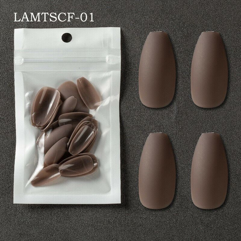 Four matte brown false press-on nails displayed next to a clear plastic resealable pouch containing the same brown nails, on a dark gray textured background. The text 'LAMTSCF-01' is printed in the top left corner.