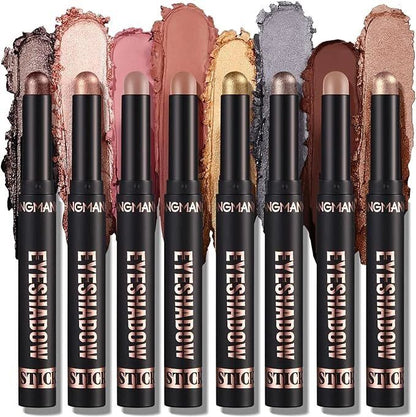 Eight black eyeshadow stick pencils with rose gold accents are lined up vertically, each showing a different eyeshadow color swatch behind it. The visible text on the sticks reads 'NGH 1A1N' and 'EYESHADOW STICK'.