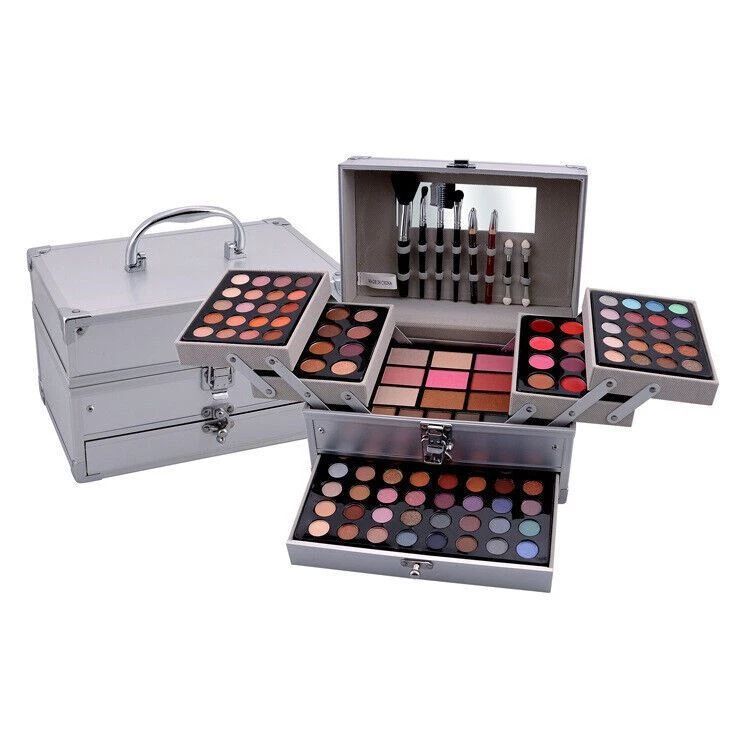 Makeup set with multiple palettes and applicators in a silver case on a white background