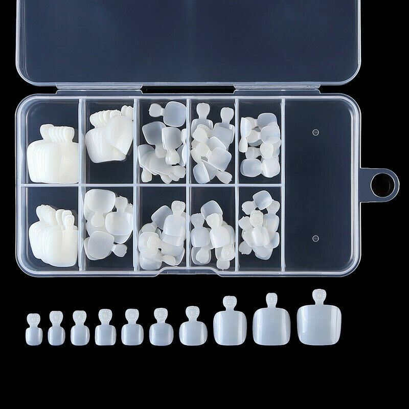 A clear plastic organizer case filled with white silicone nail tips in various shapes and sizes, with a row of matching white silicone nail tips aligned below on a black background.