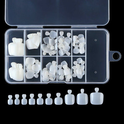 A clear plastic organizer case filled with white silicone nail tips in various shapes and sizes, with a row of matching white silicone nail tips aligned below on a black background.