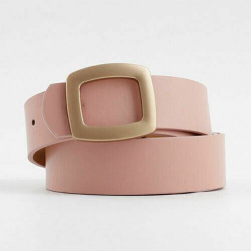 A dusty pink leather belt with a large, square, gold-tone metal buckle, coiled on a light gray background.