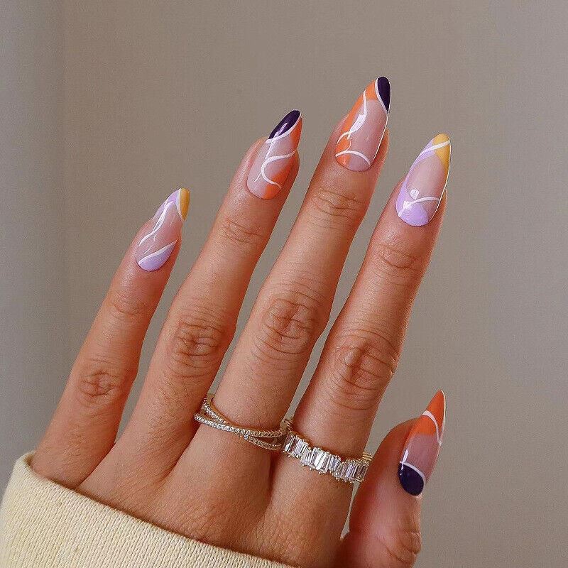 Hand with stylish nail art and rings on a neutral background