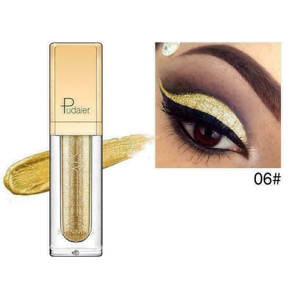 Gold eye makeup product with application on a white background