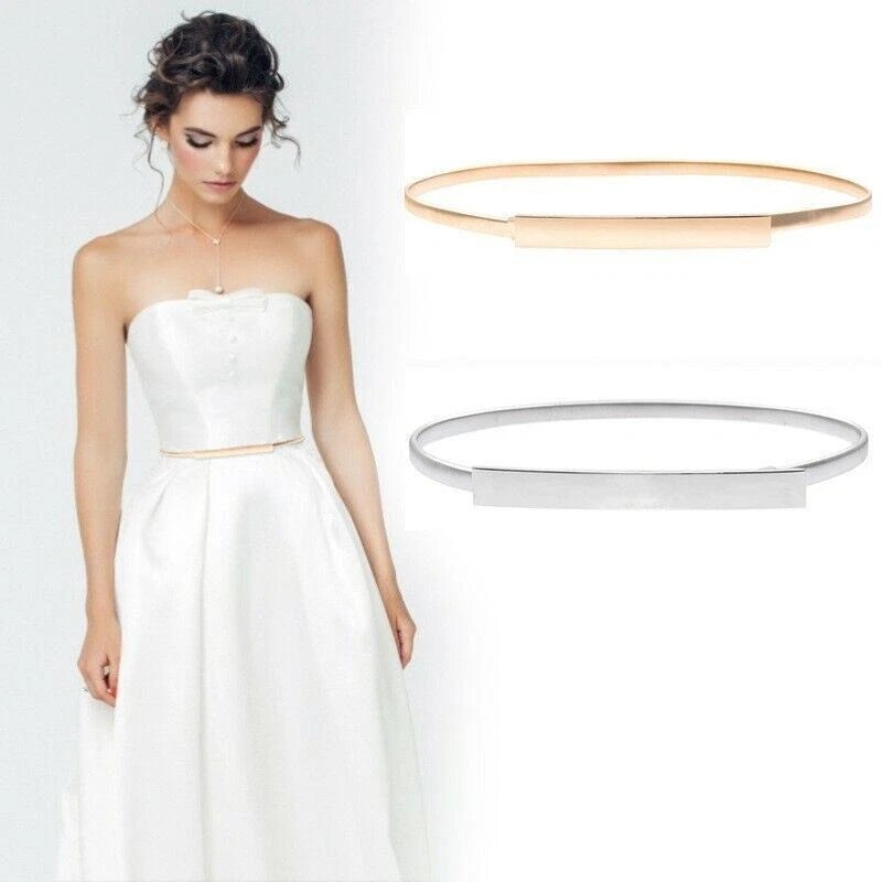 Woman in a white strapless dress with two gold rings displayed above her.