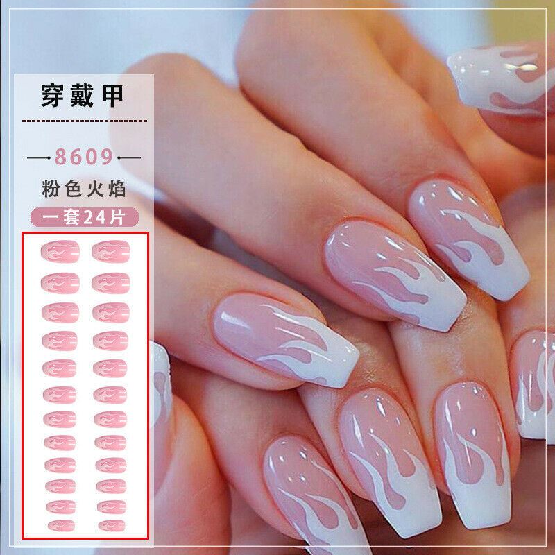Close-up of manicured hands wearing long square nails with a white-to-pale-pink gradient and pink flame-like swirl pattern. A product inset on the left shows the individual nail sticker designs and Chinese text labeling the shade as pink flame, set 24 pieces.