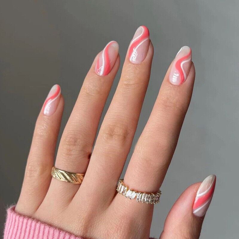 Hand with pink and white marbled nail polish on a gray background