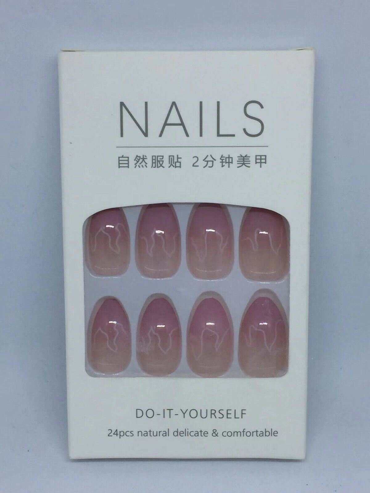 A package of 24-piece press-on nails in a white box with a clear window showing the nails. The nails are a soft pinkish nude with a white floral pattern, and the packaging has Chinese and English text.