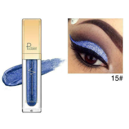 A tube of blue glitter eyeshadow or liquid makeup shown on a white background with a blue swatch behind it and a close-up eye wearing the shimmering blue shade. The tube has a gold cap and the brand name appears to read Tudaier.