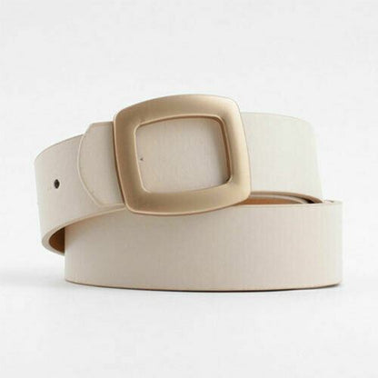 A light beige leather belt with a large, square, gold-toned metal buckle, coiled on a clean white background.