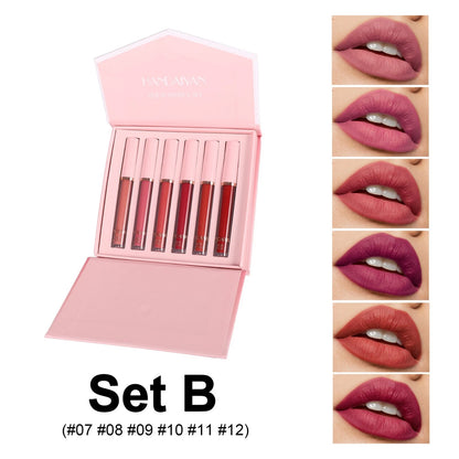 Set of lipsticks in a pink case with color swatches on a white background