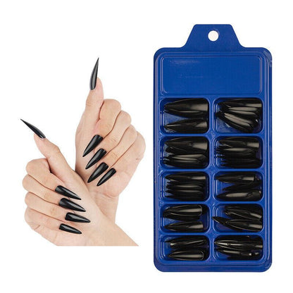 Black stiletto nail tips in a blue packaging tray with a hand model displaying the nails.