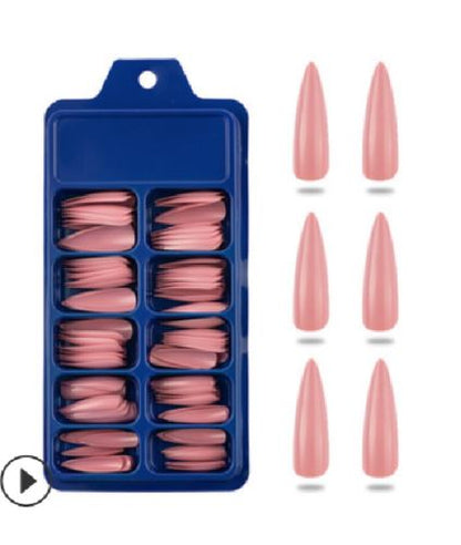 A blue plastic tray holding multiple pairs of pink false nails, shown next to six individual pointed almond-shaped pink nails on a white background.