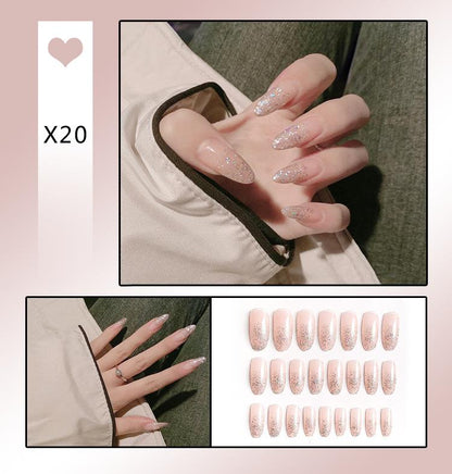 A collage showing press-on nails worn on a hand, with a pack of 20 nude pink glitter press-on nails displayed on a white background. Text reads 'X20' next to a heart icon.