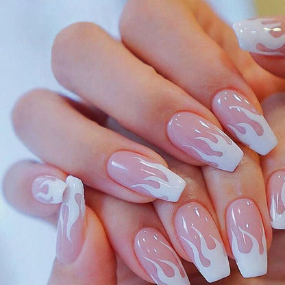 Nails with white flame design on a light background