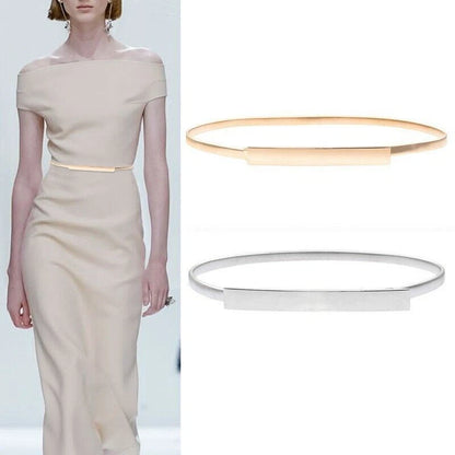 A model wears a fitted off-the-shoulder beige dress with a thin gold waistband, while the right side shows two minimalist bangle-style belt accessories in gold and silver on a white background.