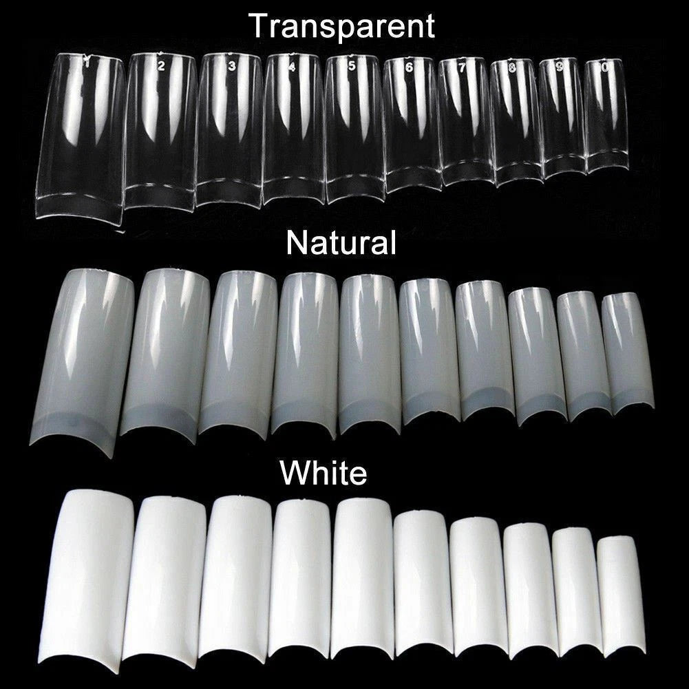 Set of clear, natural, and white nail extensions on a black background