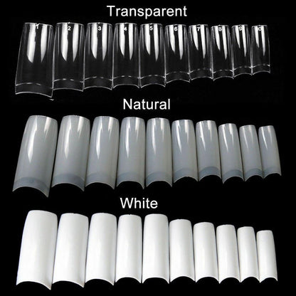 Set of clear, natural, and white nail extensions on a black background