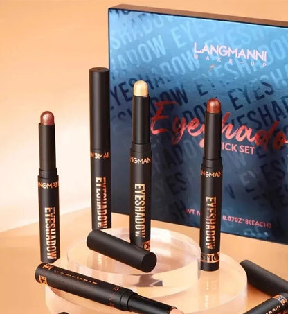 Langmanni Makeup Eyeshadow Stick Set with multiple black dual-ended makeup sticks displayed on clear acrylic stands in front of a blue branded box.