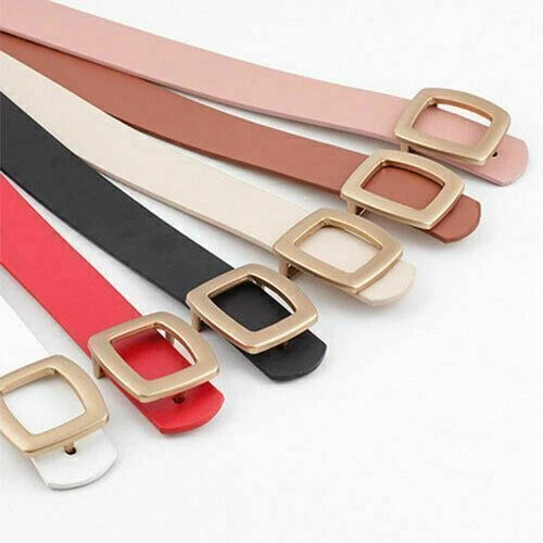 Six slim faux-leather belts in pink, brown, cream, black, red, and white, each with a square gold-tone buckle, arranged diagonally on a white background.