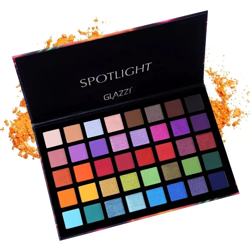 Makeup palette with various colors on a white background